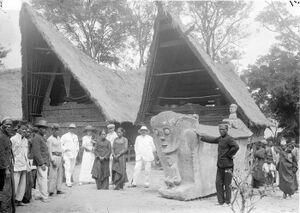 COLLECTIE TROPENMUSEUM Het hoofd van het Toba-Batak dorp Loemban Soei Soei op Samosir staat bij een stenen sarcofaag van de familie Sidabutar waarin voorouderschedels bewaard worden TMnr 10001711.jpg